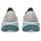 Back view of gray running shoes with a light blue sole on a white background