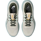 A pair of Asics running shoes shown from a top-down view, featuring a light gray and white mesh upper with dark gray laces, a light blue sole, and gold logo details.