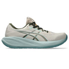 Gray running shoe with green sole on a white background