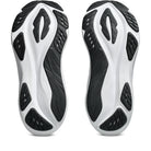 A pair of athletic shoes shown from the sole view, featuring a white and black textured design on a clean white background.