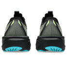 A pair of black and gray mesh athletic sneakers shown from the back, featuring lime green accents on the upper and bright turquoise outsoles, on a white background.