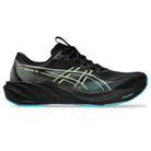 Black running shoe with green accents on a white background