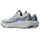 A pair of ASICS running shoes in white and gray with blue logo accents, shown from a side profile view against a white background.