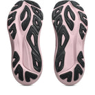 Pink and black athletic shoes with unique sole design on a white background