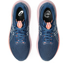 Blue running shoes with pink accents on a white background