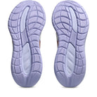 Purple shoe soles with tread pattern on a white background