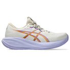 White running shoe with orange and purple accents on a white background