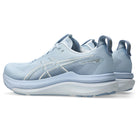 Light blue running shoe with white sole on a white background