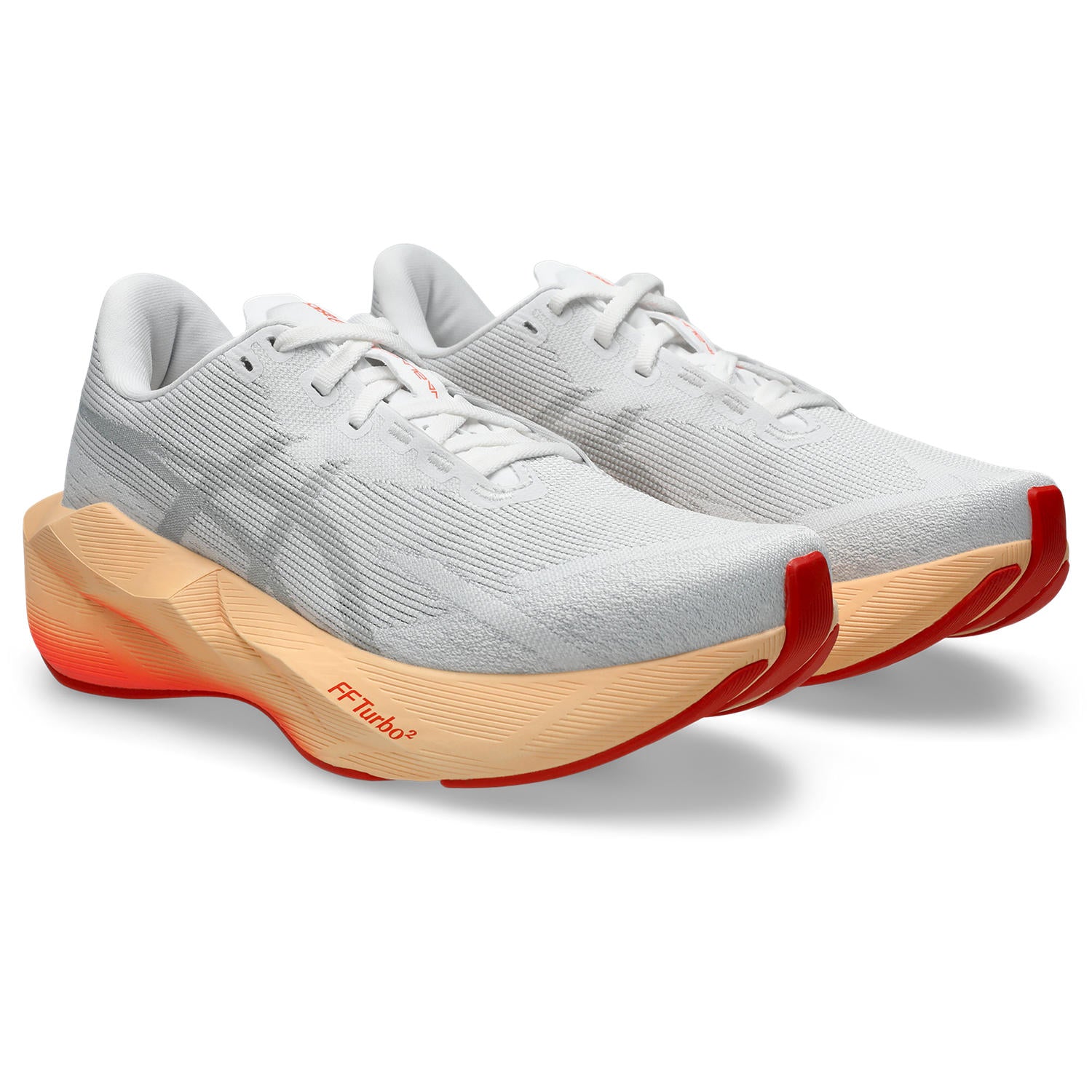White running shoes with orange soles on a white background