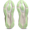 Close-up of a pair of shoes with green and beige sole design on a white background