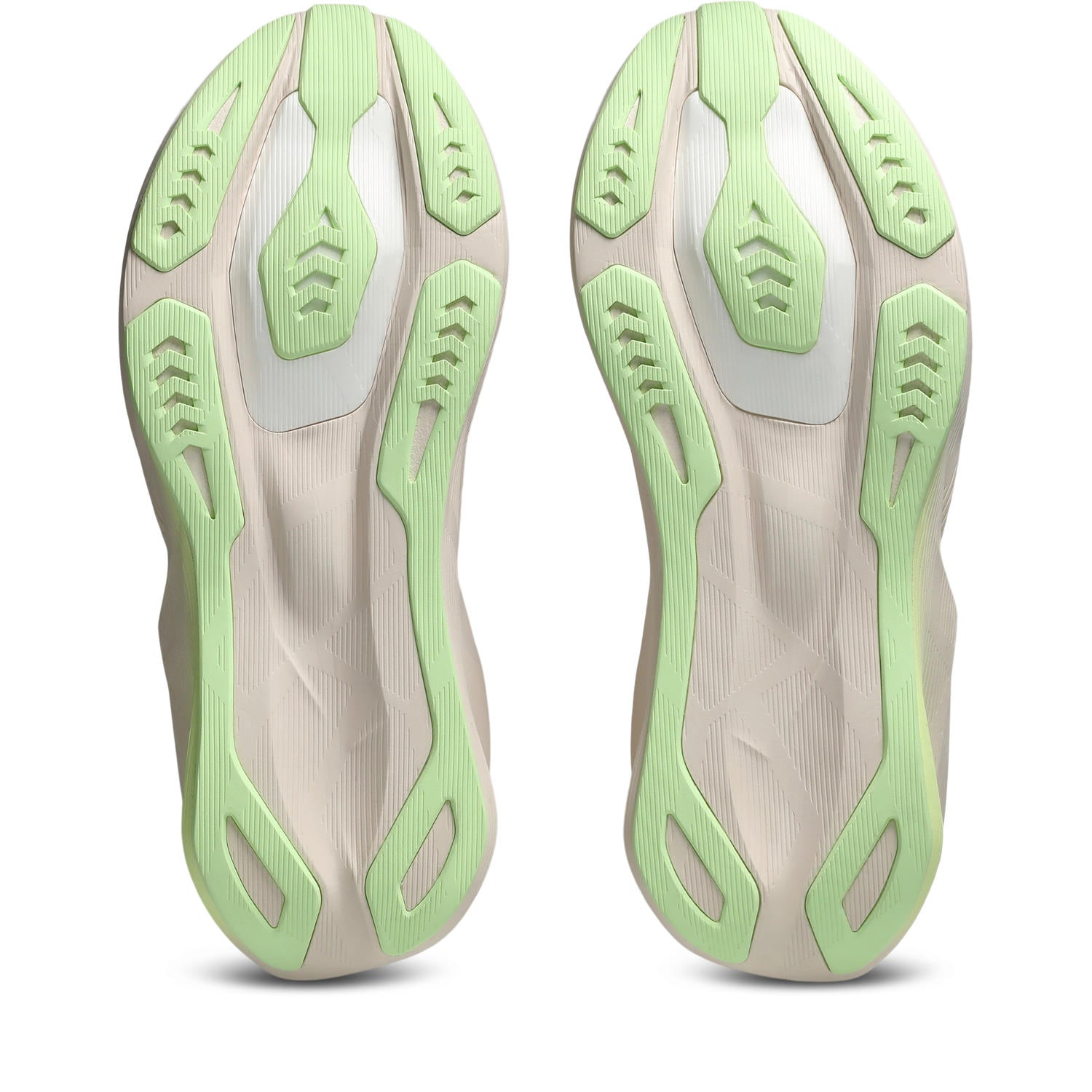 Close-up of a pair of shoes with green and beige sole design on a white background