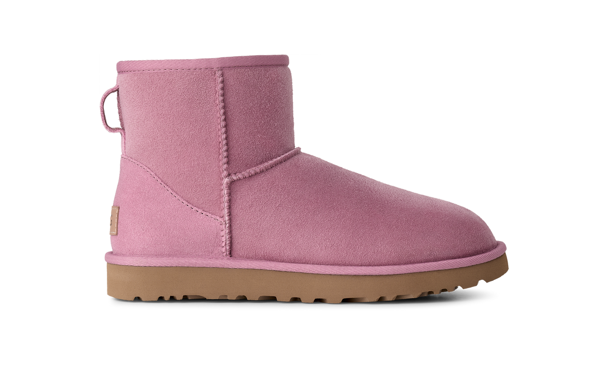 A single pink suede ankle boot with a tan rubber sole, shown in a side profile on a solid white background.