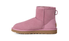 A single pink suede ankle boot with a tan sole, shown in a side profile on a solid white background.