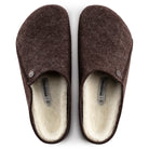 Pair of brown slippers with white lining on a white background
