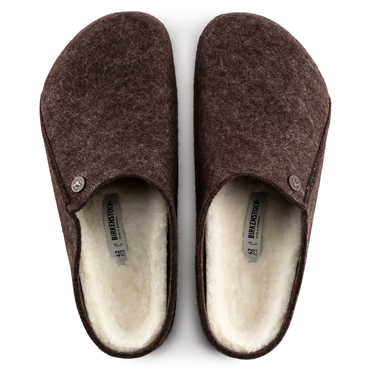 Pair of brown slippers with white lining on a white background