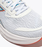Close-up of a running shoe with white sole and gray upper
