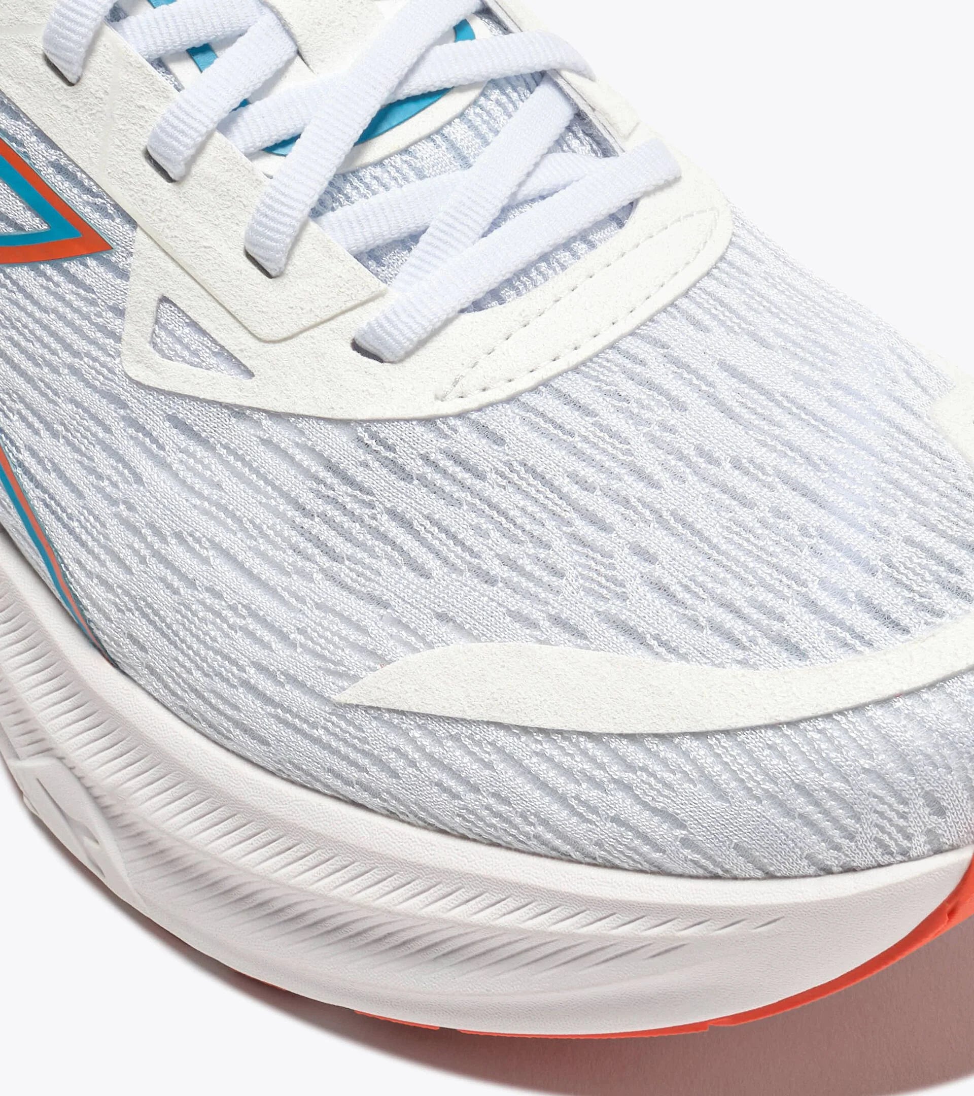 Close-up of a running shoe with white sole and gray upper
