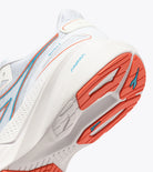 Close-up of a running shoe with orange and white design on a white background