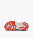 Close-up of a running shoe with orange and white sole on a white background