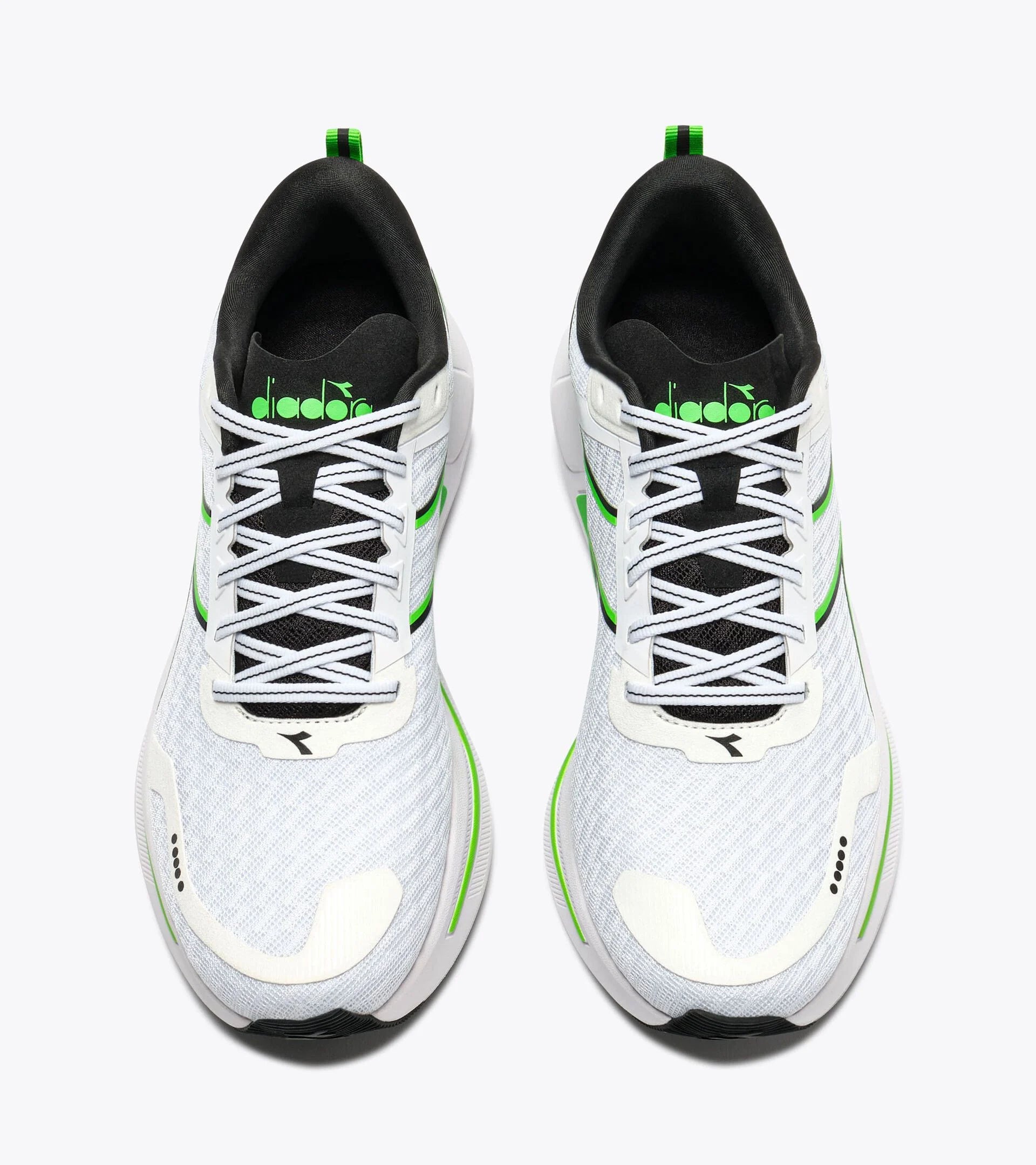 White sneakers with black and green accents on a white background