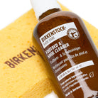 Birkenstock footbed and shoe cleaner bottle with a yellow sponge on a white background