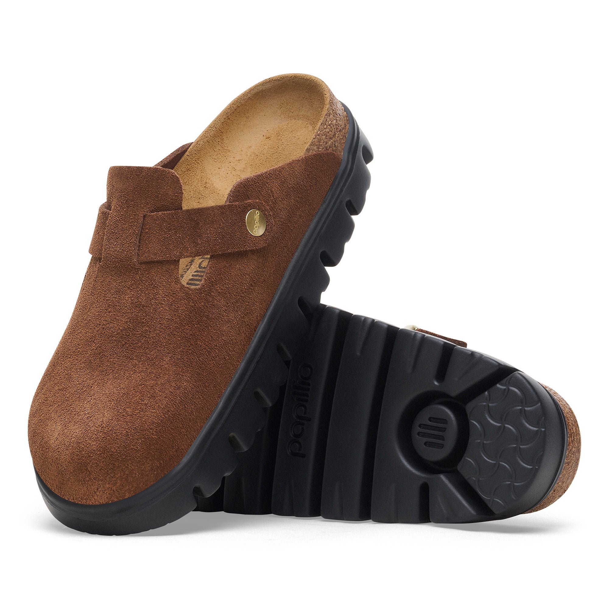 Brown clog shoe with black sole on a white background