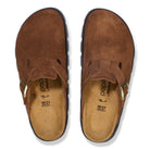 Brown suede clogs with a visible brand logo on a white background