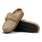 Pair of beige loafers with a textured sole on a white background