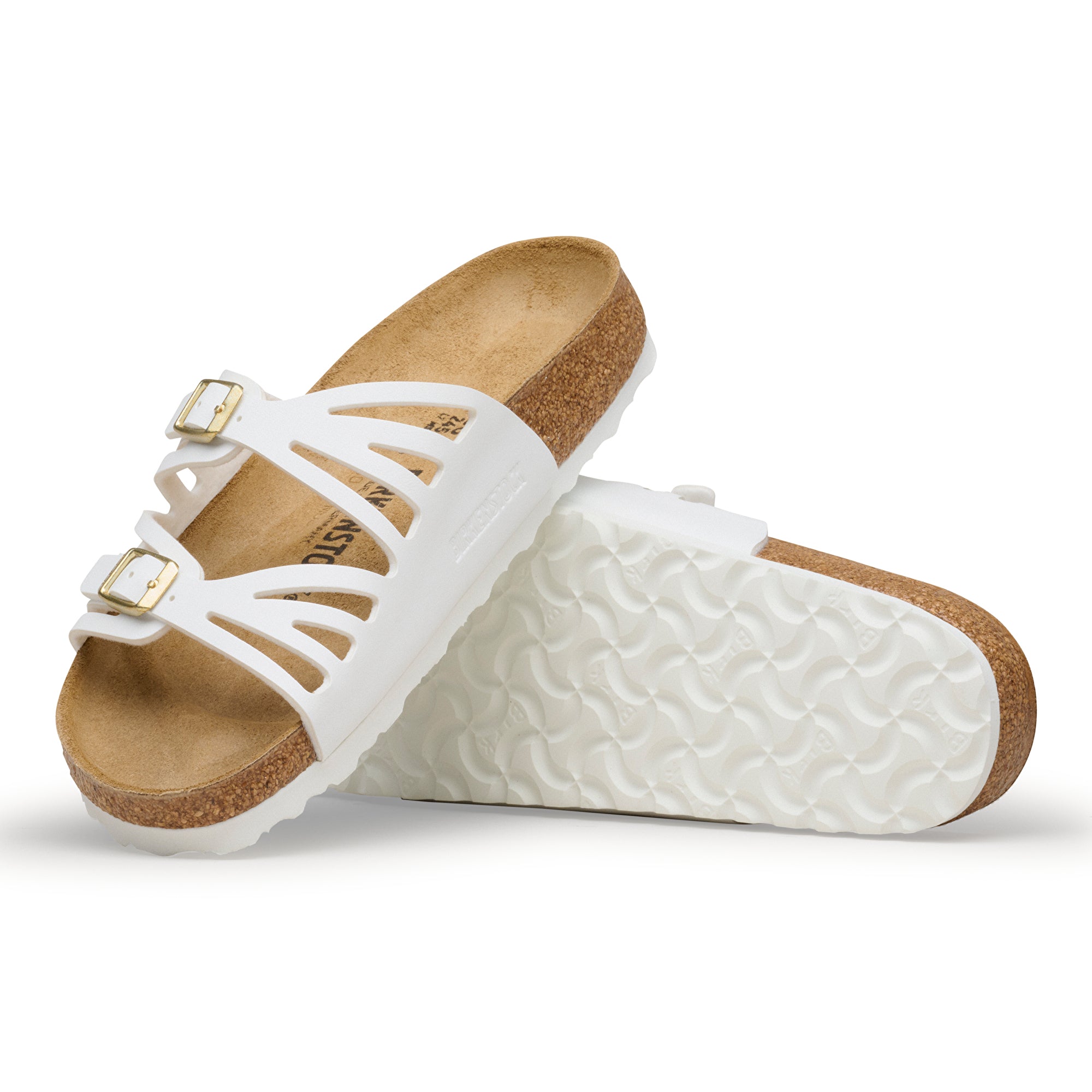 White sandal with brown cork sole on a white background