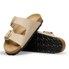 Beige sandals with cork sole on a white background