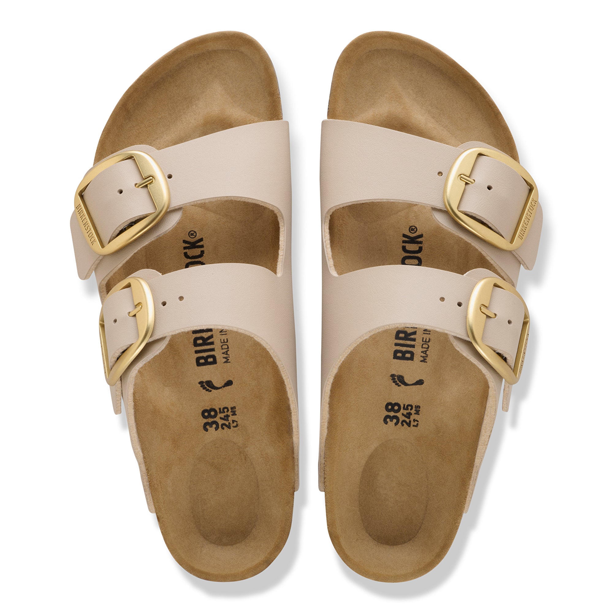 Beige sandals with gold buckles on a white background