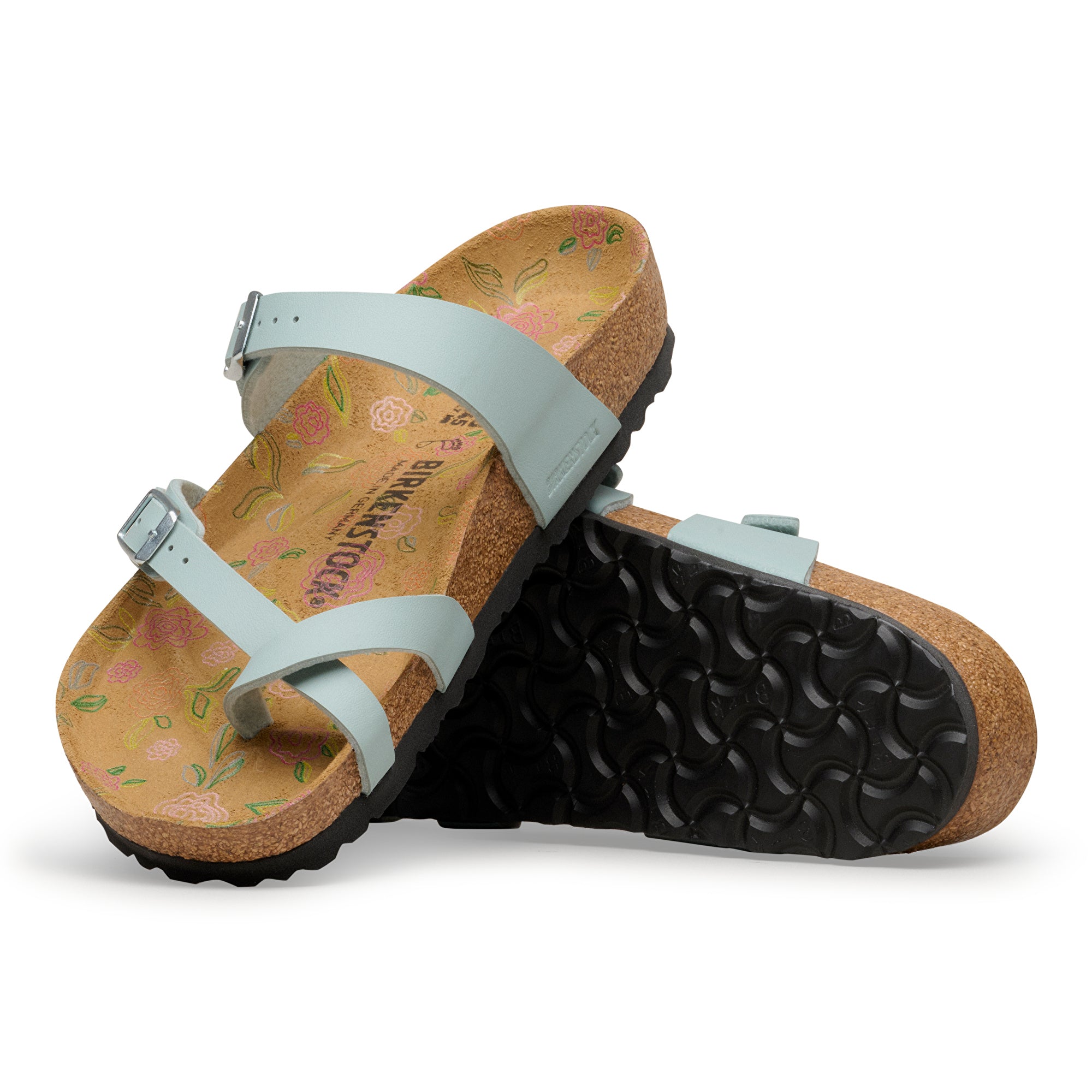 Pair of sandals with floral pattern on a white background
