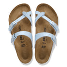 Pair of Birkenstock sandals with light blue straps on a white background