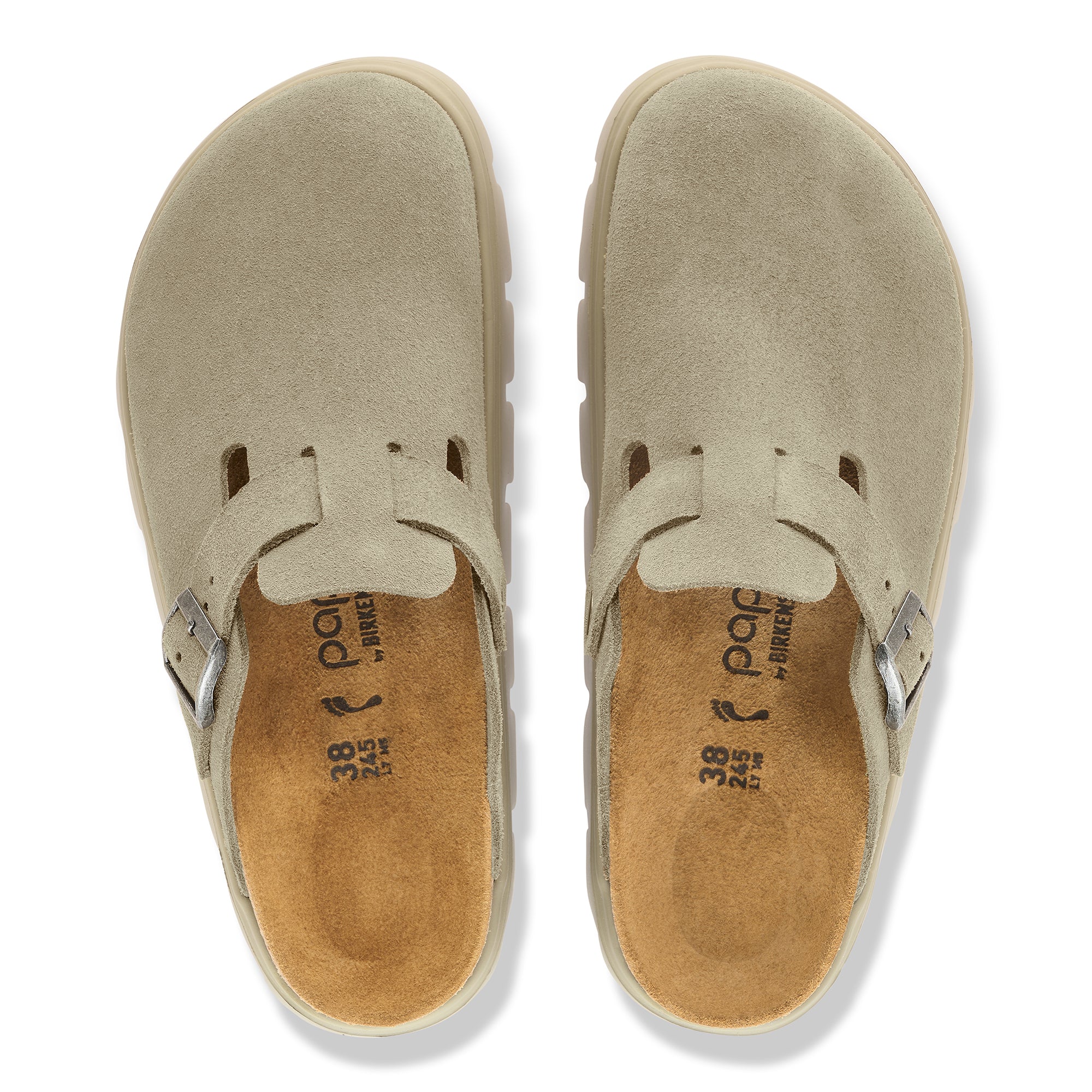 Pair of beige slip-on shoes with a white background