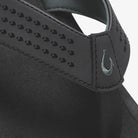 Close-up of a black visor with a brand logo on a white background