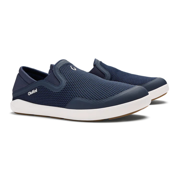 Navy slip-on shoes with white soles on a white background