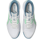 White sneakers with green and blue accents on a white background