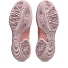 Pink athletic shoe sole with tread pattern on a white background