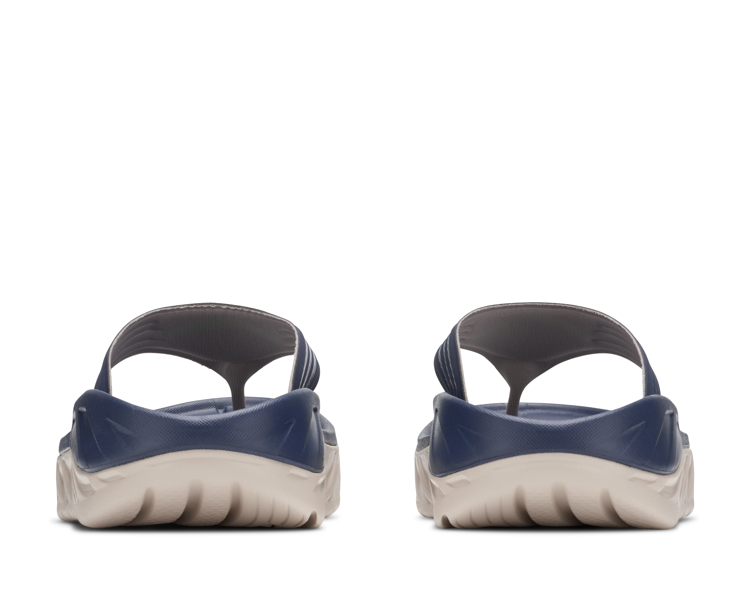 Pair of navy and beige sandals on a white background