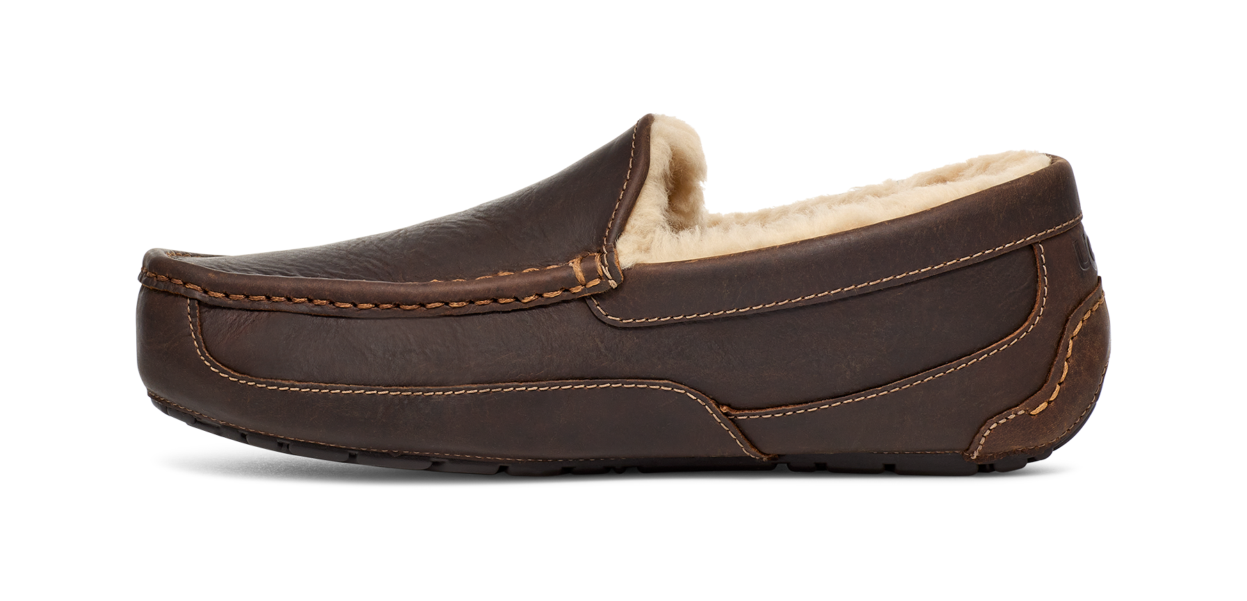 A dark brown leather slip-on loafer with a soft cream-colored shearling lining, shown from a side profile view against a white background.