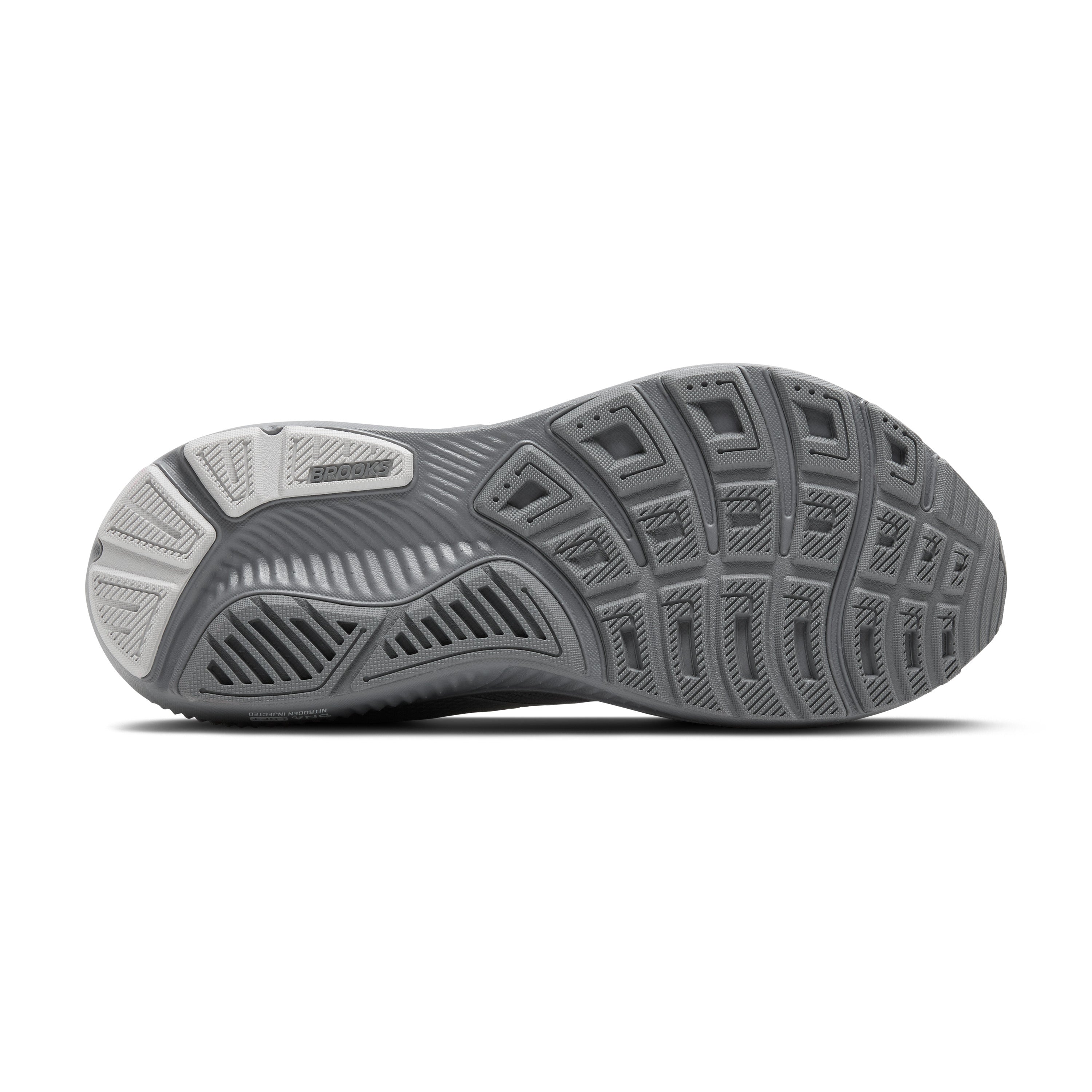 Close-up of a running shoe sole with tread pattern on a white background
