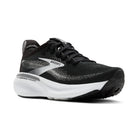 Black and white running shoe with 'Brooks' branding on a white background