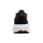 Black and white sneaker with brown sole on a white background