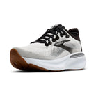 White running shoe with black laces and brown sole on a white background