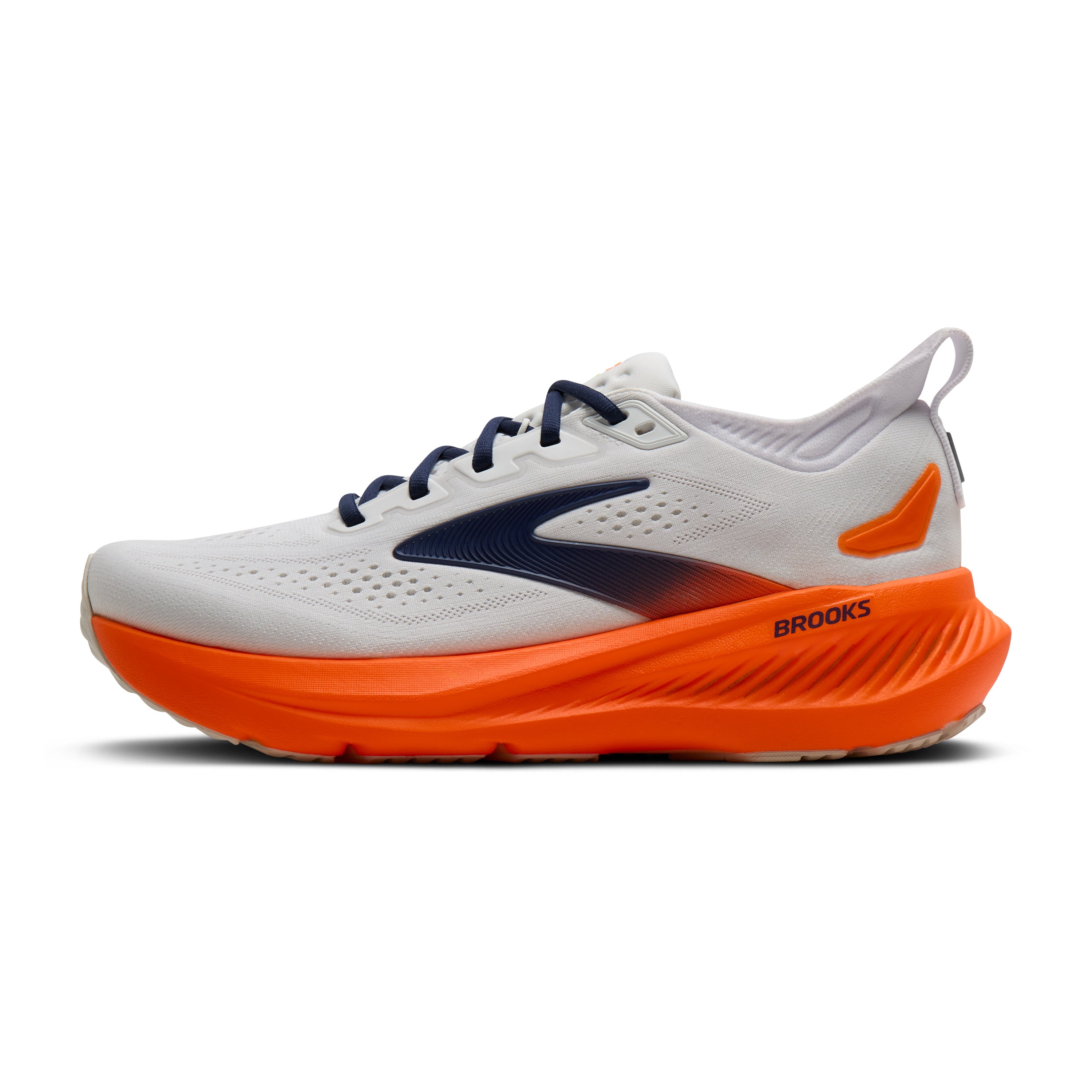 White running shoe with orange sole on a white background