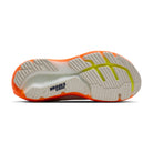 Sole of a running shoe with orange and green accents on a white background