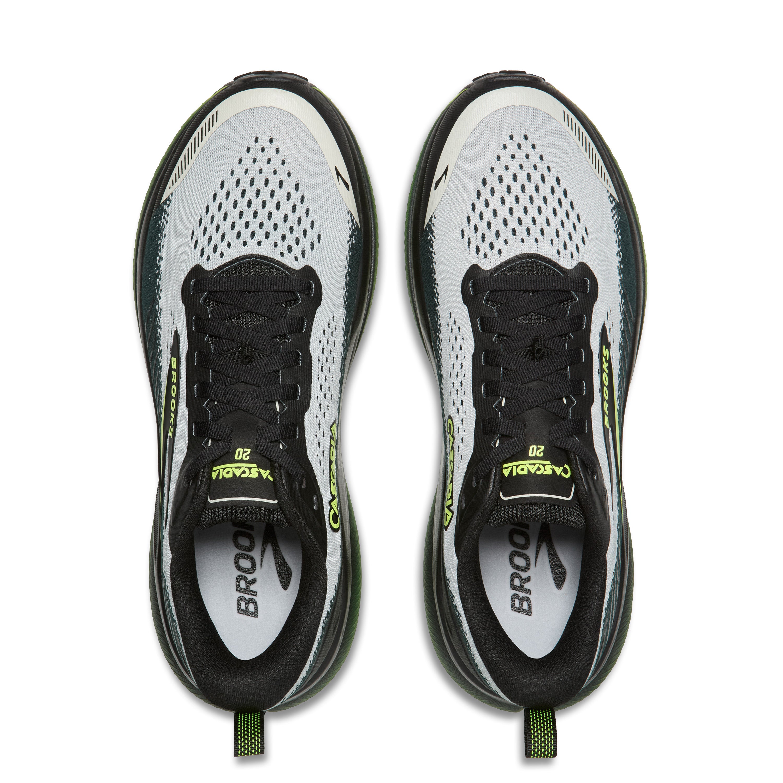 Pair of black and white running shoes with green accents on a white background
