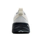 White athletic shoe with black sole on a white background