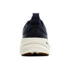 Navy running shoe with white sole on a white background