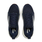 Navy running shoes with white soles on a white background
